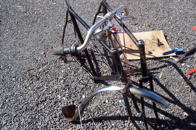 two stripped roadster frames